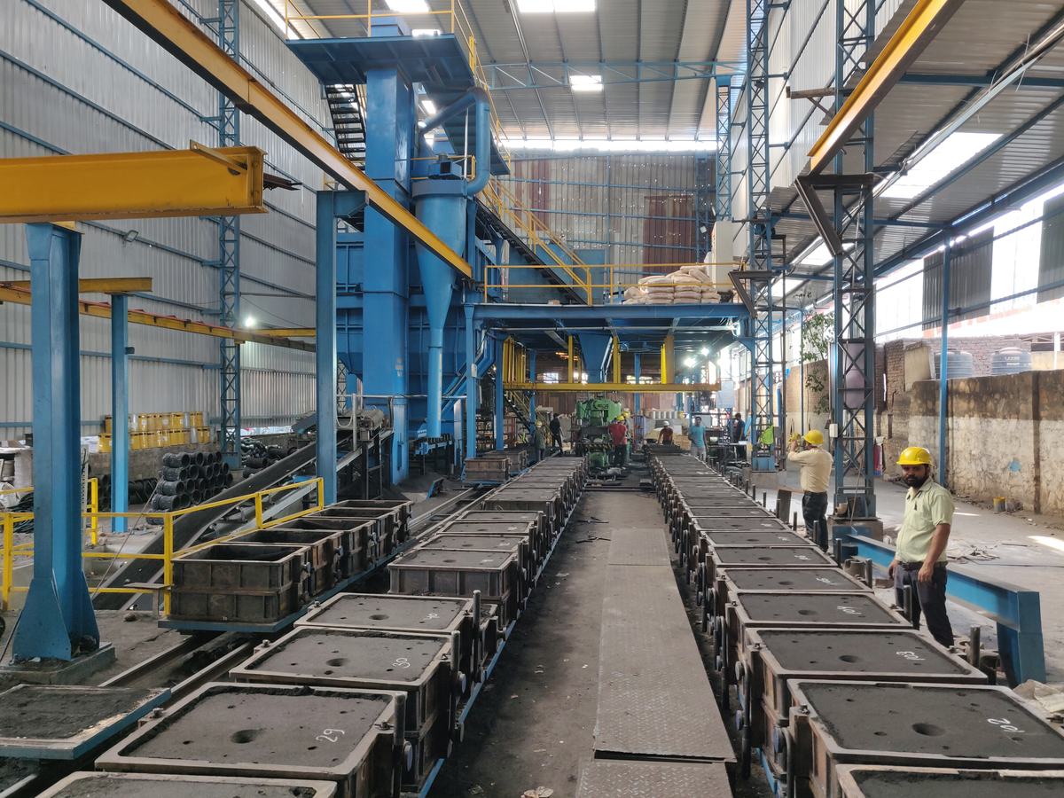 Long row of moulding boxes on a roller line inside the Bikaner Engineering Works foundry shed